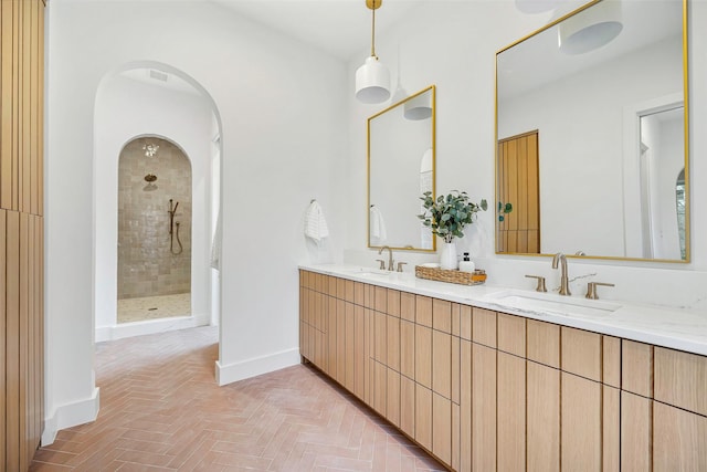 2212 Ridge Crest Dr, Richardson, TX 75080 - full bathroom featuring double vanity, baseboards, a tile shower, and a sink