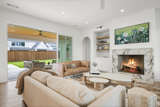 2212 Ridge Crest Dr, Richardson, TX 75080 - living area featuring recessed lighting, ceiling fan, built in features, wood finished floors, and a fireplace