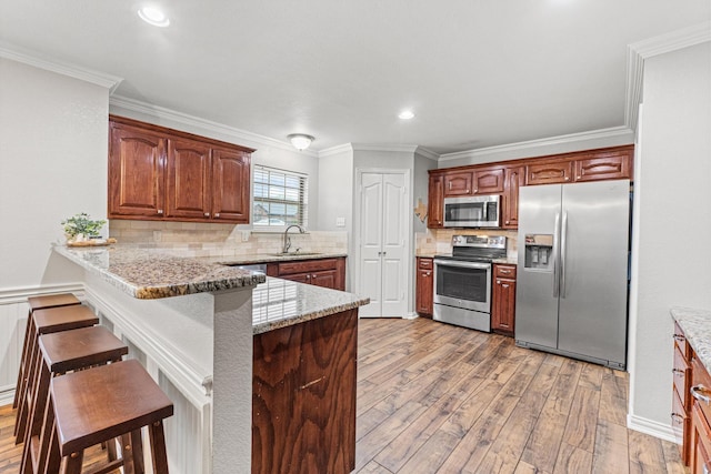 10121 Fireside Ln, Forney, TX 75126 - kitchen with a sink, a peninsula, visible vents, dark wood-style flooring, and appliances with stainless steel finishes
