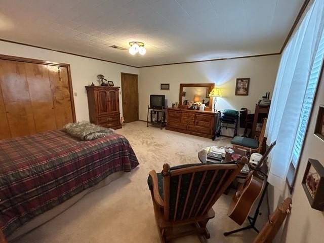 carpeted bedroom featuring visible vents