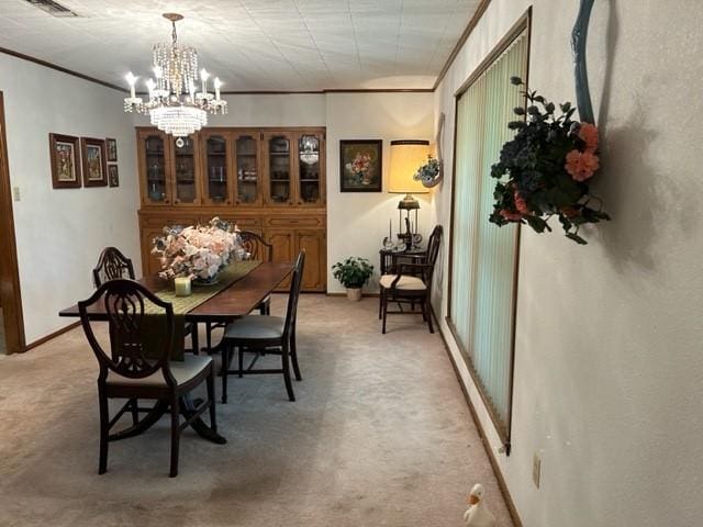 dining room featuring crown molding, light carpet, a notable chandelier, and visible vents