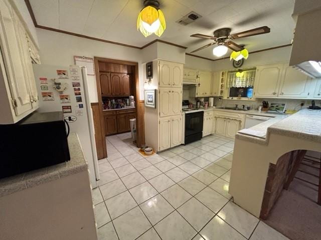 kitchen with light tile patterned floors, white appliances, light countertops, and visible vents