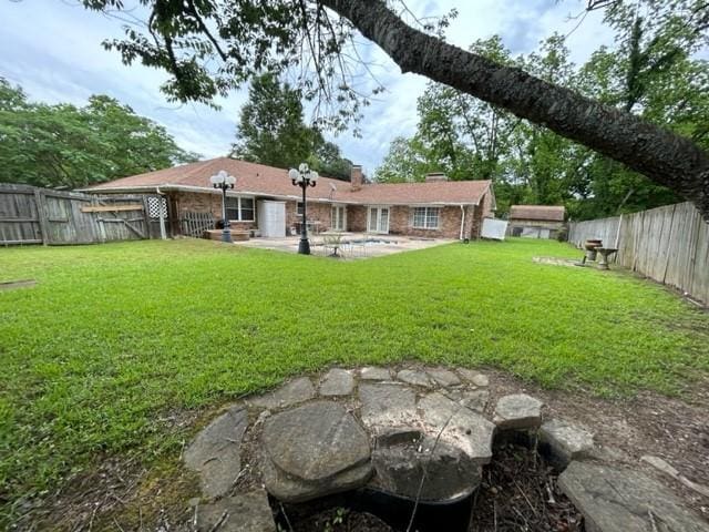 view of yard featuring a patio and a fenced backyard