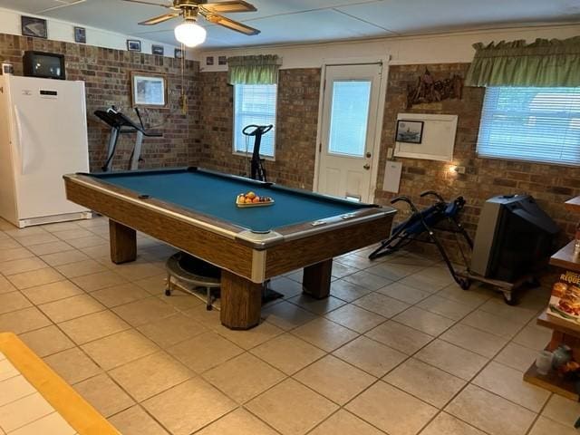 recreation room featuring brick wall, billiards, a ceiling fan, and light tile patterned floors