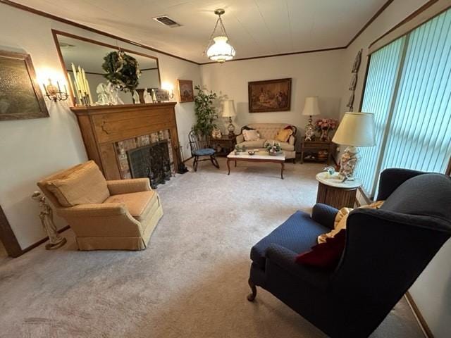 living room featuring a fireplace, ornamental molding, carpet floors, and visible vents
