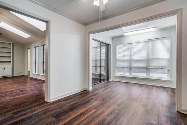 2 Preston Trail Ct, Pantego, TX 76013 - empty room with vaulted ceiling with skylight, dark wood-type flooring, baseboards, ceiling fan, and ornamental molding
