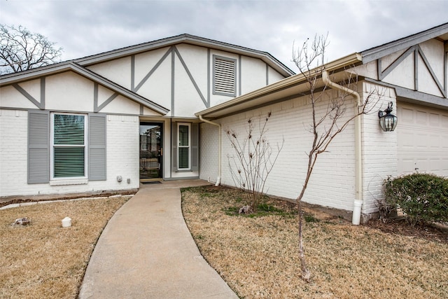 2 Preston Trail Ct, Pantego, TX 76013 - tudor home with an attached garage, stucco siding, and brick siding
