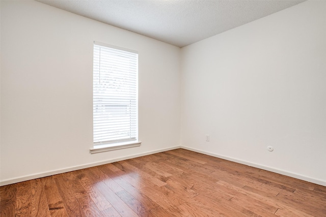 2 Preston Trail Ct, Pantego, TX 76013 - spare room featuring wood finished floors and baseboards