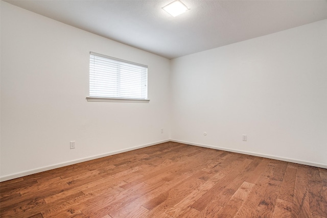 2 Preston Trail Ct, Pantego, TX 76013 - empty room with baseboards and light wood-style floors
