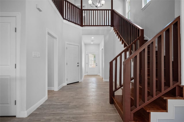 121 County Road 3471, Paradise, TX 76073 - entryway featuring an inviting chandelier, wood finished floors, a high ceiling, stairway, and baseboards