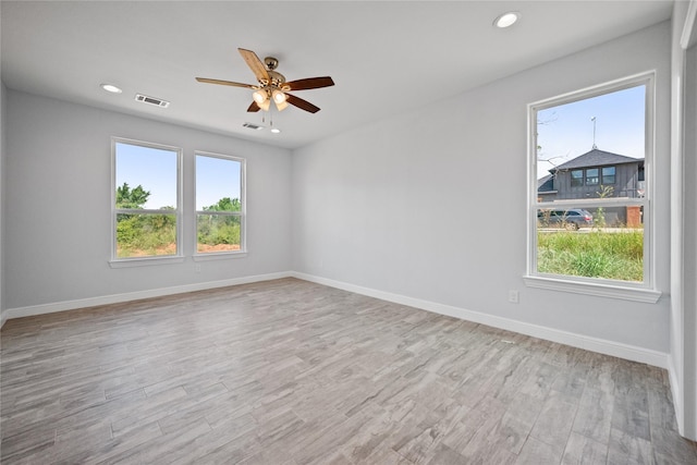 121 County Road 3471, Paradise, TX 76073 - spare room with wood finished floors, visible vents, baseboards, and a ceiling fan