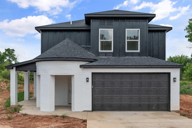 121 County Road 3471, Paradise, TX 76073 - view of front of home featuring concrete driveway, board and batten siding, brick siding, and roof with shingles