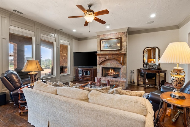 living room with ornamental molding, visible vents, a ceiling fan, and dark wood-type flooring