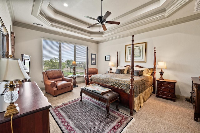 bedroom featuring a tray ceiling, ornamental molding, light carpet, and visible vents