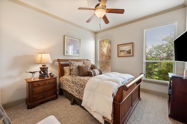 bedroom with light colored carpet, ornamental molding, baseboards, and a ceiling fan