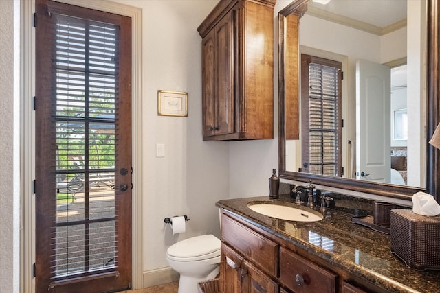 half bathroom with vanity and toilet