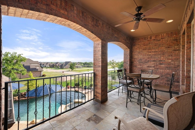 balcony with a ceiling fan and a residential view