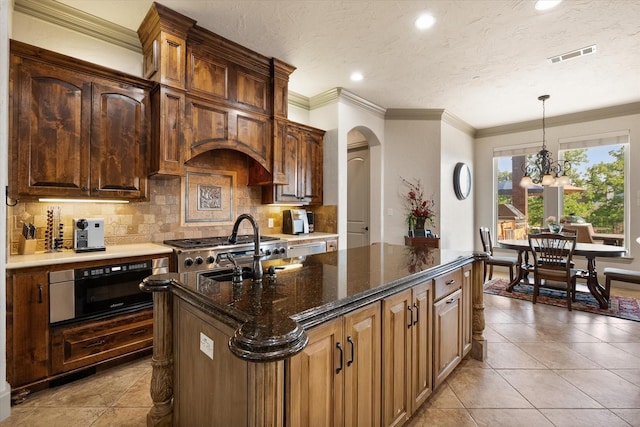 kitchen with backsplash, arched walkways, wall oven, and light tile patterned floors
