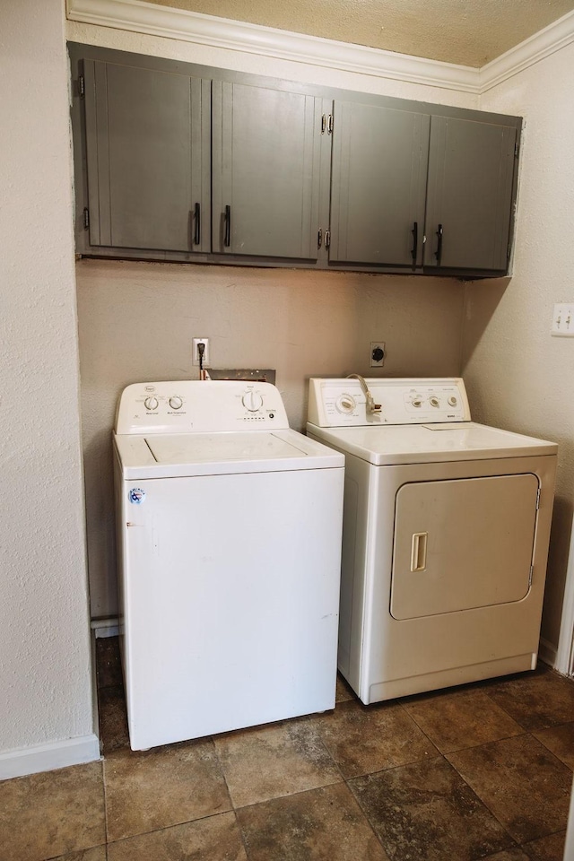 521 E 8th St, Bonham, TX 75418 - laundry room featuring baseboards, stone finish flooring, crown molding, washer and clothes dryer, and cabinet space