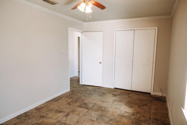 521 E 8th St, Bonham, TX 75418 - unfurnished bedroom with baseboards, a closet, stone finish flooring, and crown molding