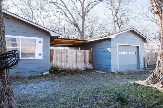 521 E 8th St, Bonham, TX 75418 - exterior space featuring an outbuilding, fence, and a garage