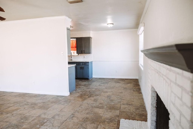 521 E 8th St, Bonham, TX 75418 - unfurnished living room featuring crown molding, baseboards, a fireplace, and stone finish flooring