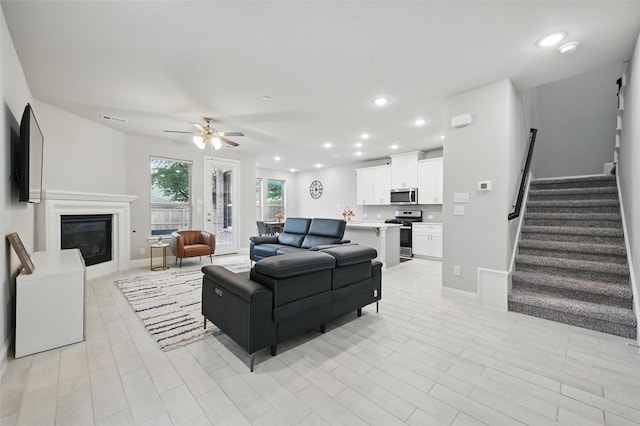3045 Hamilton St, Plano, TX 75075 - living area with stairs, visible vents, recessed lighting, ceiling fan, and a glass covered fireplace