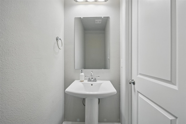 3045 Hamilton St, Plano, TX 75075 - bathroom with a textured wall and a sink