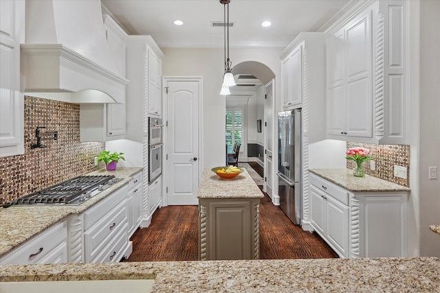 kitchen featuring dark wood finished floors, white cabinets, appliances with stainless steel finishes, and custom range hood
