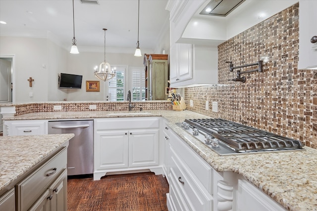 kitchen with white cabinetry, stainless steel appliances, a peninsula, and a sink
