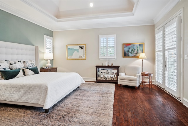 bedroom with crown molding, baseboards, dark wood-style flooring, and a raised ceiling