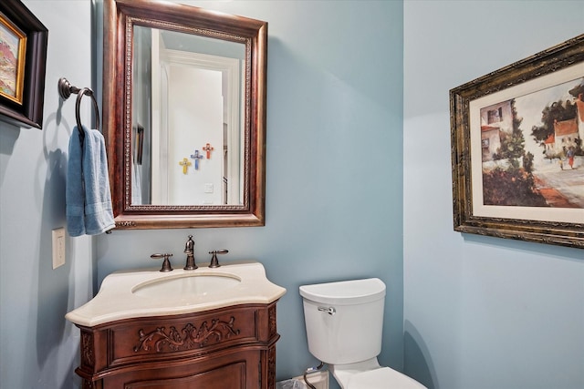 half bath featuring toilet and vanity