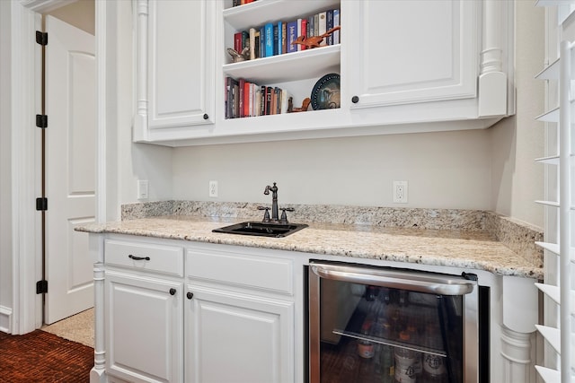 bar featuring a sink, beverage cooler, and indoor wet bar
