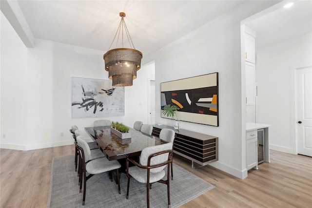 dining space with light wood finished floors and baseboards
