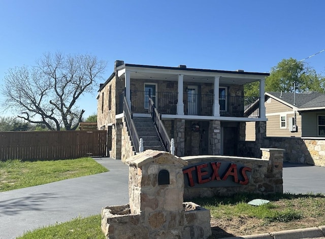 414 Ussery, Bowie, TX 76230 - view of front of house featuring stone siding, fence, and stairs