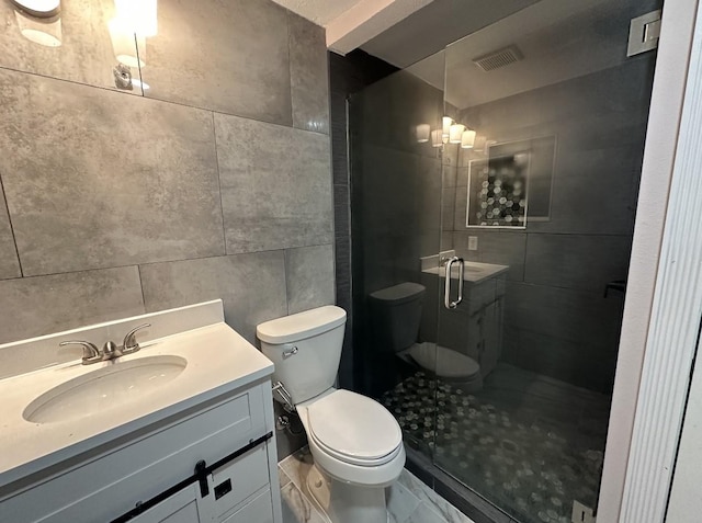 414 Ussery, Bowie, TX 76230 - full bath featuring a shower stall, tile walls, vanity, and toilet