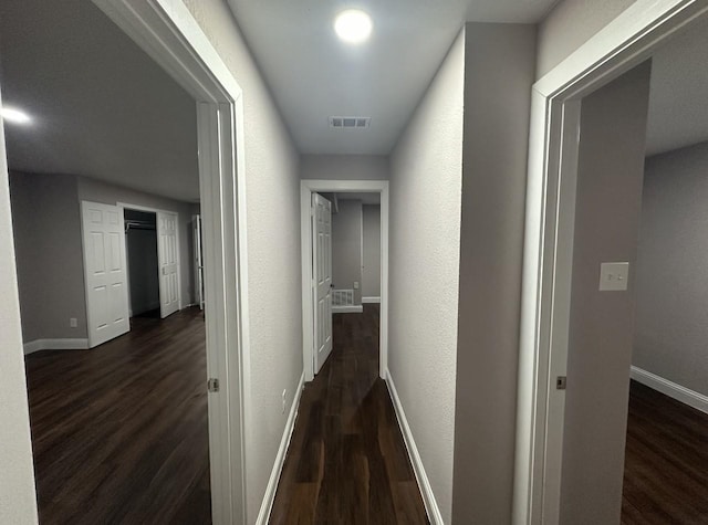 414 Ussery, Bowie, TX 76230 - hallway with baseboards, dark wood-style flooring, and visible vents