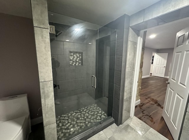 414 Ussery, Bowie, TX 76230 - full bathroom with a stall shower, toilet, and baseboards