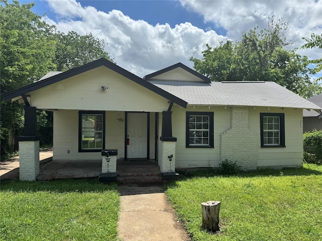 3616 Ave Ave N, Fort Worth, TX 76105 - view of front of house featuring a front yard, a shingled roof, and covered porch