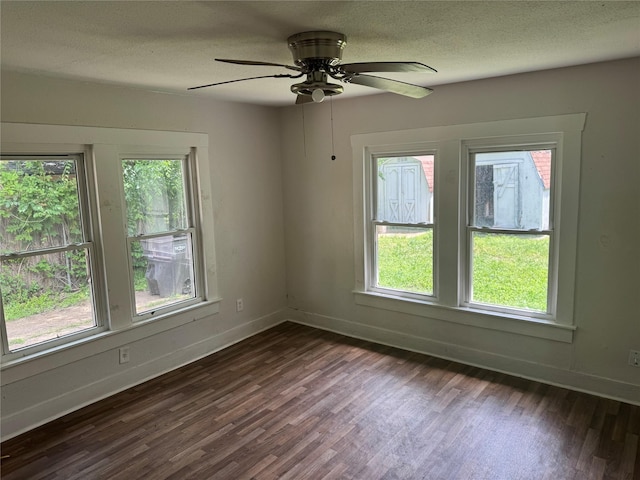 3616 Ave Ave N, Fort Worth, TX 76105 - unfurnished room featuring a textured ceiling, dark wood finished floors, and plenty of natural light