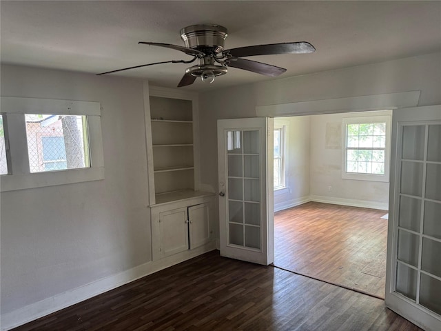 3616 Ave Ave N, Fort Worth, TX 76105 - unfurnished room with dark wood finished floors, built in features, baseboards, and ceiling fan