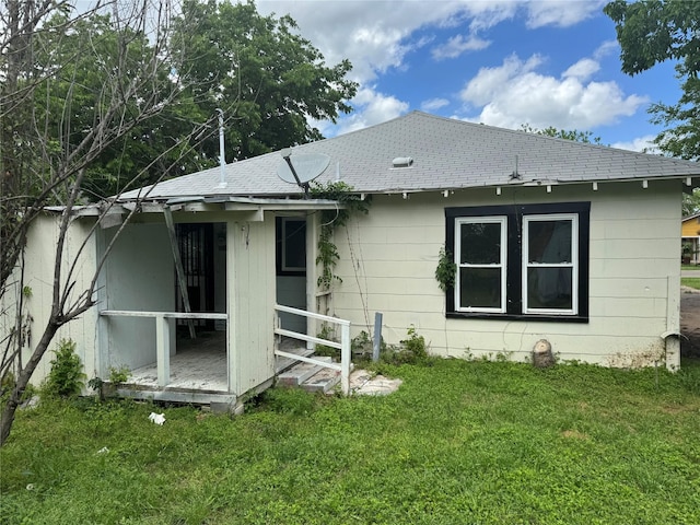 3616 Ave Ave N, Fort Worth, TX 76105 - rear view of house featuring a shingled roof and a lawn