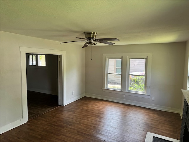 3616 Ave Ave N, Fort Worth, TX 76105 - spare room featuring baseboards, dark wood-style flooring, a textured ceiling, and a ceiling fan