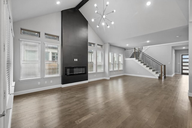 13101 Scissortail Dr, Frisco, TX 75035 - unfurnished living room featuring high vaulted ceiling, stairs, baseboards, a chandelier, and healthy amount of natural light