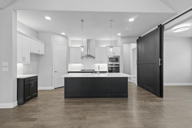 13101 Scissortail Dr, Frisco, TX 75035 - kitchen featuring wall chimney exhaust hood, stainless steel appliances, a sink, a barn door, and light countertops