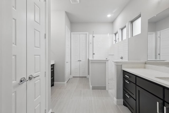 13101 Scissortail Dr, Frisco, TX 75035 - bathroom with walk in shower, vanity, tile patterned flooring, a closet, and baseboards