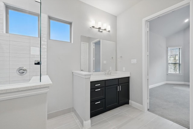 13101 Scissortail Dr, Frisco, TX 75035 - bathroom featuring healthy amount of natural light, walk in shower, tile patterned flooring, and vanity