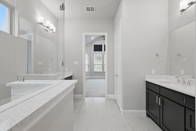 13101 Scissortail Dr, Frisco, TX 75035 - full bathroom with baseboards, ceiling fan, and two vanities