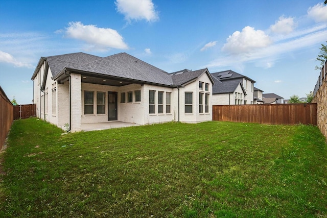 13101 Scissortail Dr, Frisco, TX 75035 - back of house featuring a patio, brick siding, and a shingled roof