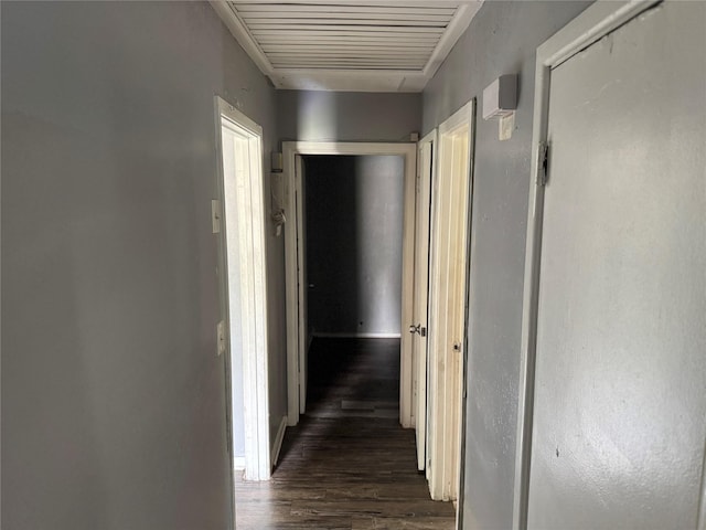 hallway featuring dark wood-type flooring and visible vents